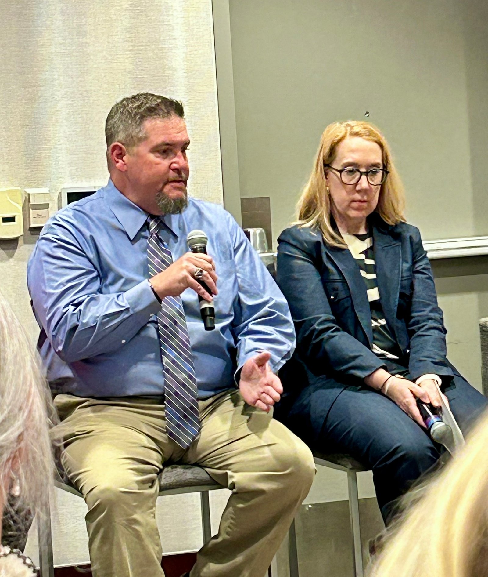 Eric Butcher speaking into a microphone during a healthcare panel discussion
